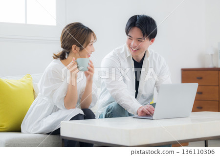 Young couple looking at a personal computer 136110306