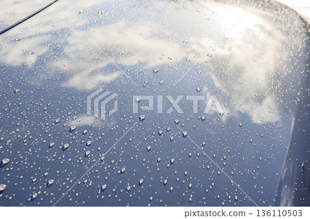 Countless shining droplets and reflections on the hood after the rain Countless shining droplets and reflections on the hood after the rain 136110503