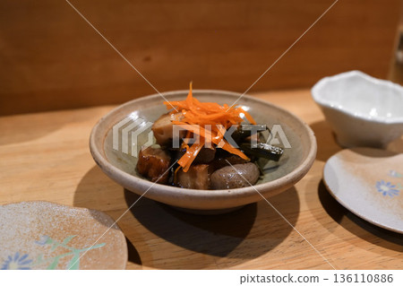 Japanese simmered dishes and small side dishes placed on a wooden counter Japanese simmered dishes and small side dishes placed on a wooden counter 136110886