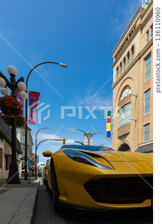 Yellow Ferrari 812 superfast parked on the street of Victoria city in the blue sky background 136110960