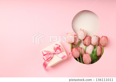 Pink tulips and a gift box create a festive spring scene Pink tulips and a gift box create a festive spring scene 136111011