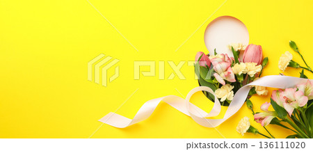 Colorful spring flowers with a ribbon on a bright background Colorful spring flowers with a ribbon on a bright background 136111020