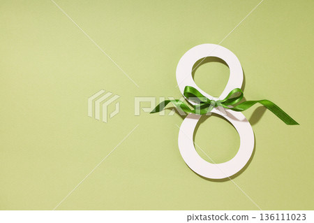 Green background with a ribboned decorative eight 136111023