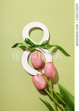 Pink tulips and a decorative eight symbol celebrate women 136111024
