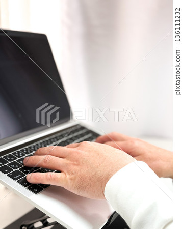 Male hand operating a personal computer Male hand operating a personal computer 136111232