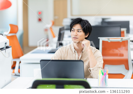 A young businessman working in the office A young businessman working in the office 136111293