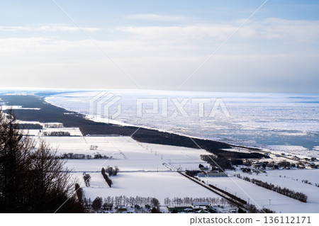 A photo of the tranquil landscape of the land and sky of eastern Hokkaido in winter, overlooking the Sea of Okhotsk covered in drift ice. A photo of the tranquil landscape of the land and sky of eastern Hokkaido in winter, overlooking the Sea of Okhotsk covered in drift ice. 136112171