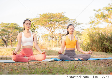 Fit woman practicing yoga outdoor. Calmness and relax. fitness, yoga training, lifestyle. 136112734