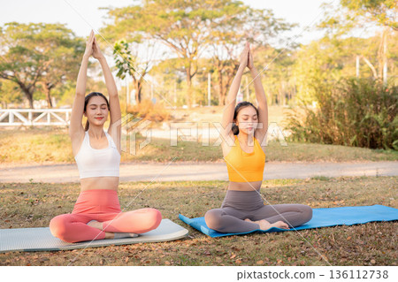 Fit woman practicing yoga outdoor. Calmness and relax. fitness, yoga training, lifestyle. Fit woman practicing yoga outdoor. Calmness and relax. fitness, yoga training, lifestyle. 136112738