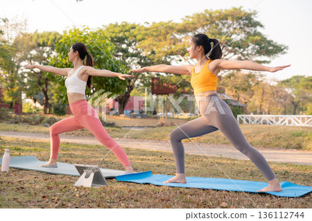 Fit woman practicing yoga outdoor. Calmness and relax. fitness, yoga training, lifestyle. Fit woman practicing yoga outdoor. Calmness and relax. fitness, yoga training, lifestyle. 136112744
