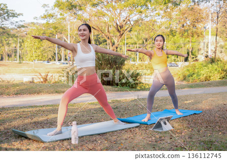 Fit woman practicing yoga outdoor. Calmness and relax. fitness, yoga training, lifestyle. Fit woman practicing yoga outdoor. Calmness and relax. fitness, yoga training, lifestyle. 136112745
