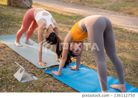 Fit woman practicing yoga outdoor. Calmness and relax. fitness, yoga training, lifestyle. 136112750