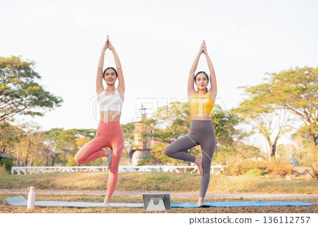Fit woman practicing yoga outdoor. Calmness and relax. fitness, yoga training, lifestyle. 136112757