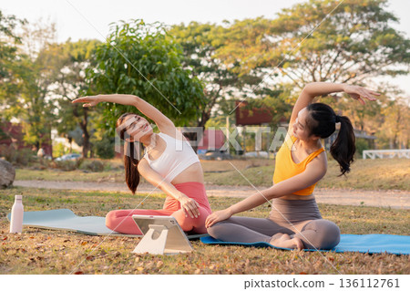 Fit woman practicing yoga outdoor. Calmness and relax. fitness, yoga training, lifestyle. 136112761