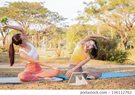 Fit woman practicing yoga outdoor. Calmness and relax. fitness, yoga training, lifestyle. Fit woman practicing yoga outdoor. Calmness and relax. fitness, yoga training, lifestyle. 136112762