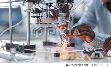 A person crafting a product using a 3D printer in a well-lit workspace. 136113194