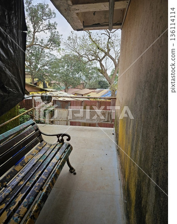 Quiet walkway with a bench beside an old building in Matheran, offering a glimpse of simple hill town architecture and peaceful everyday surroundings. Quiet walkway with a bench beside an old building in Matheran, offering a glimpse of simple hill town architecture and peaceful everyday surroundings. 136114114
