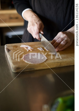 Cutting ham with a knife Cutting ham with a knife 136114156