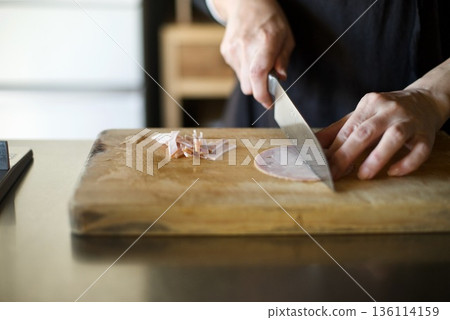 Cutting ham with a knife Cutting ham with a knife 136114159