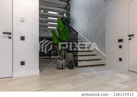 Modern minimalist staircase with glass railings and tropical decor Modern minimalist staircase with glass railings and tropical decor 136114312