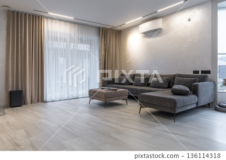 Spacious modern living room with sectional sofa and terrace access 136114318