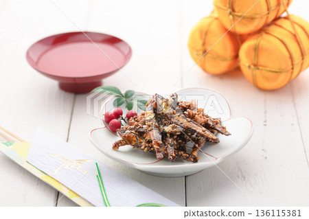 A classic New Year's dish: Sesame beans and tazukuri. Small fish tsukudani. A glossy Japanese dish with plenty of sesame. White background A classic New Year's dish: Sesame beans and tazukuri. Small fish tsukudani. A glossy Japanese dish with plenty of sesame. White background 136115381