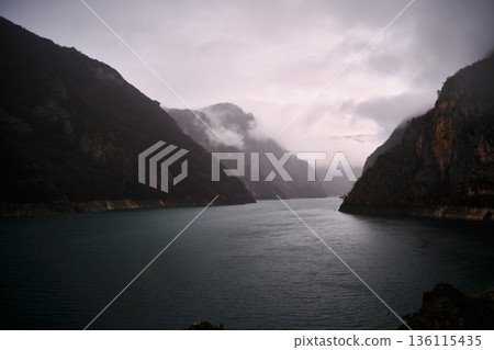 Misty mountain reservoir with calm water 136115435