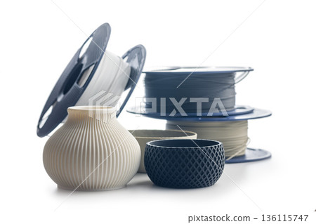 Plastic filament for 3D printer and printed products isolated on white background. 136115747