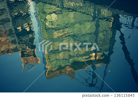 Shadow of a building reflected on the water Shadow of a building reflected on the water 136115845