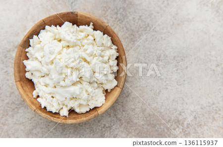 Cottage cheese in wooden bowl on rustic background 136115937