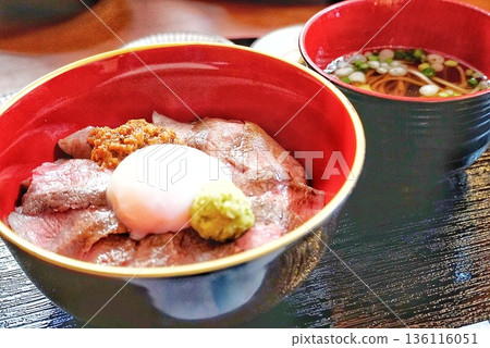 A delicious beef bowl topped with a soft-boiled egg A delicious beef bowl topped with a soft-boiled egg 136116051