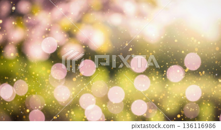 blurred background natural green and yellow foliage with sunbeams shining through leaves creating warm summer vibe sparkling dust particles magical forest atmosphere outdoor 136116986