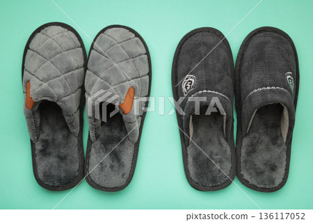 Household grey slippers on mint background. Space for text Household grey slippers on mint background. Space for text 136117052