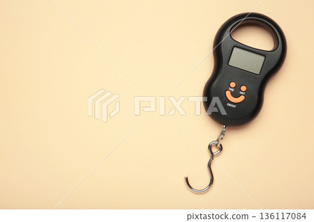 Small portable electronic scale on beige background. Space for text Small portable electronic scale on beige background. Space for text 136117084