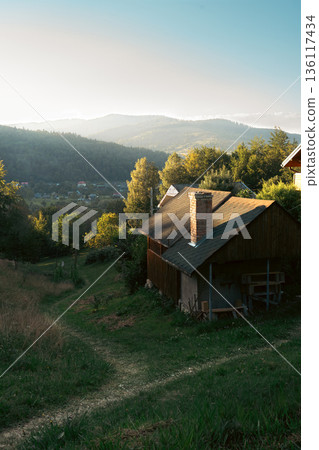 Small Wooden House on Hillside at Sunset 136117434