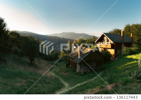 Small Wooden House on Hillside at Sunset Small Wooden House on Hillside at Sunset 136117443