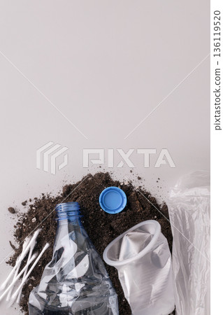Plastic waste polluting soil with disposable items Plastic waste polluting soil with disposable items 136119520