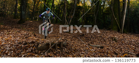 Autumn Mountain Biker Navigates Leaf-Covered Forest Trail With Focus, Energy, And Adventure Autumn Mountain Biker Navigates Leaf-Covered Forest Trail With Focus, Energy, And Adventure 136119773