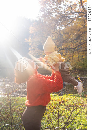 Father and Baby Enjoying Autumn in the Park 136120334