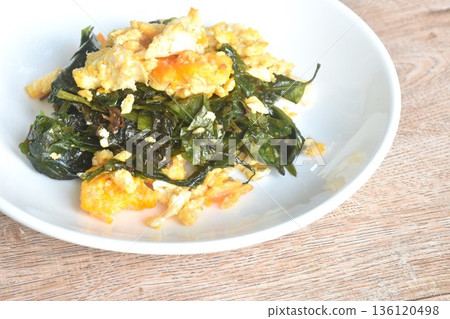 fried Melinjo tropical vegetable with egg on plate fried Melinjo tropical vegetable with egg on plate 136120498