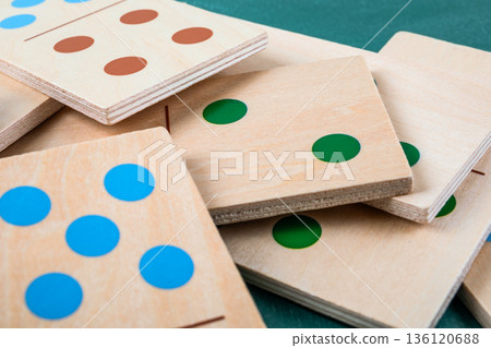 Wooden Domino Tiles With Colored Dots Stacked In Close Up Wooden Domino Tiles With Colored Dots Stacked In Close Up 136120688