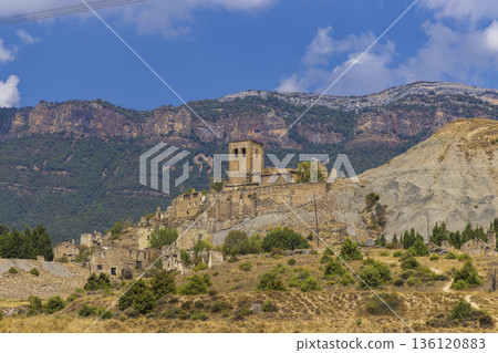 Abandoned village Sasue showing old ruins and bell tower in Sigues Abandoned village Sasue showing old ruins and bell tower in Sigues 136120883