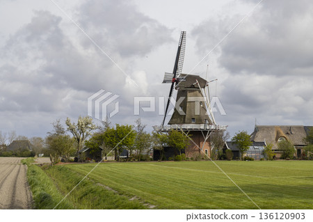 Traditional Dutch windmill standing in rural Peazens Friesland Traditional Dutch windmill standing in rural Peazens Friesland 136120903