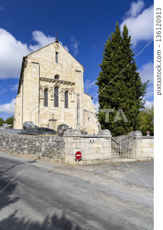Romanesque church in French countryside with a blue sky and white clouds 136120913