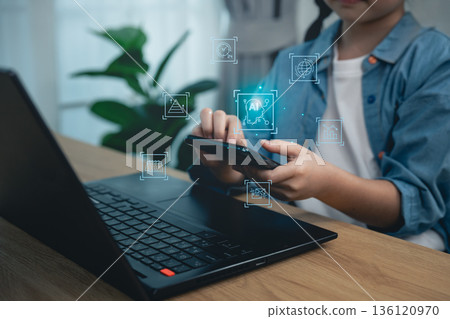 Close-up, Hand girl using magnifying glass with laptop and virtual security shield, concept of cyber safety, data analysis, internet privacy protection, and digital literacy for children Close-up, Hand girl using magnifying glass with laptop and virtual security shield, concept of cyber safety, data analysis, internet privacy protection, and digital literacy for children 136120970