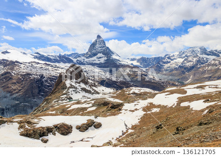 Scenic view on snowy Matterhorn mountain peak in sunny day with blue sky in Switzerland. Beautiful nature background of Swiss Alps covered with snow. Famous travel destination 136121705