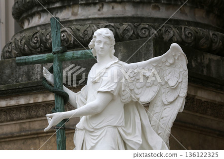 Angel statue in front of Karlskirche in Vienna, Austria Angel statue in front of Karlskirche in Vienna, Austria 136122325