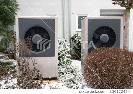 Outdoor heat pump units in residential area during winter Outdoor heat pump units in residential area during winter 136122454