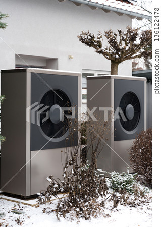 Outdoor heat pump units in residential area during winter Outdoor heat pump units in residential area during winter 136122478