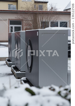 Outdoor heat pump units in snowy residential area 136122506